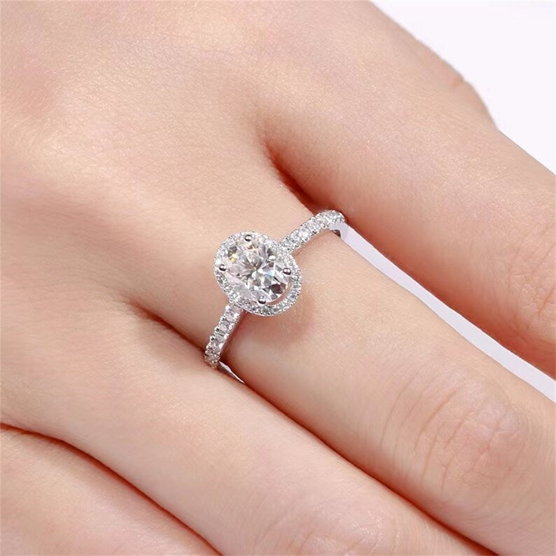 
                  
                    1.0 CT Oval Shaped Moissanite Engagement Ring With Halo Pave Accents
                  
                