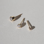 0.20 TCW Round Cut Moissanite Bezel Earrings in Gold 1