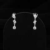 0.83 TCW Round, Pear & Emerald Cut Moissanite Earrings in Gold 1