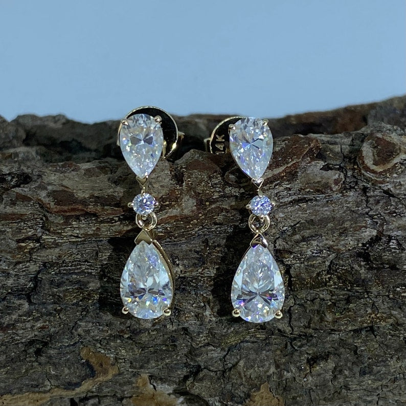 
                  
                    0.06 TCW Pear Cut Dangle Moissanite Earrings
                  
                