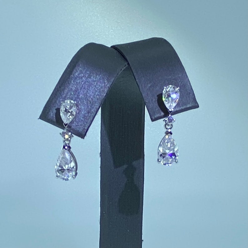 
                  
                    0.06 TCW Pear Cut Dangle Moissanite Earrings
                  
                