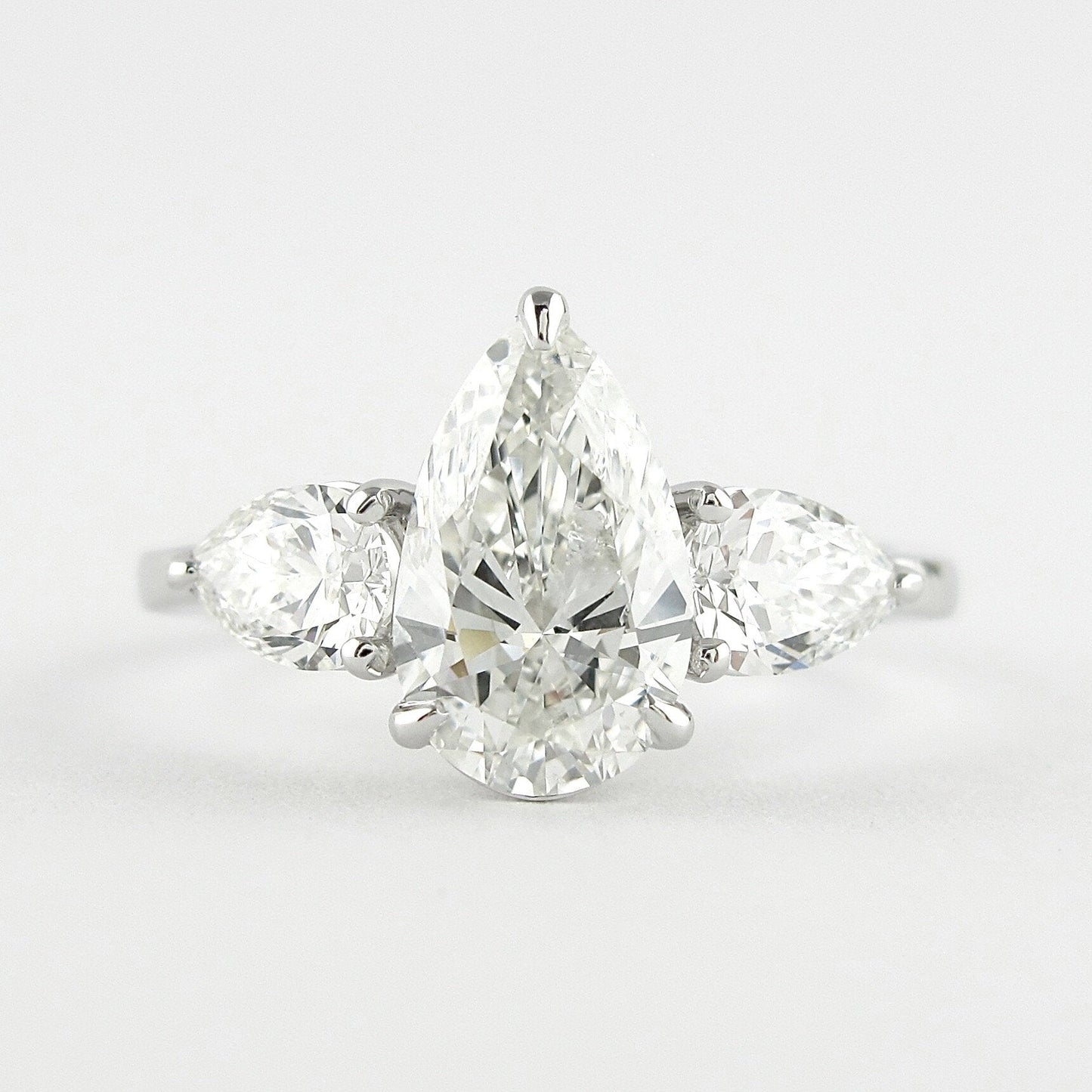 1.50 CT Pear Cut Three Stone Style Moissanite Engagement Ring 1
