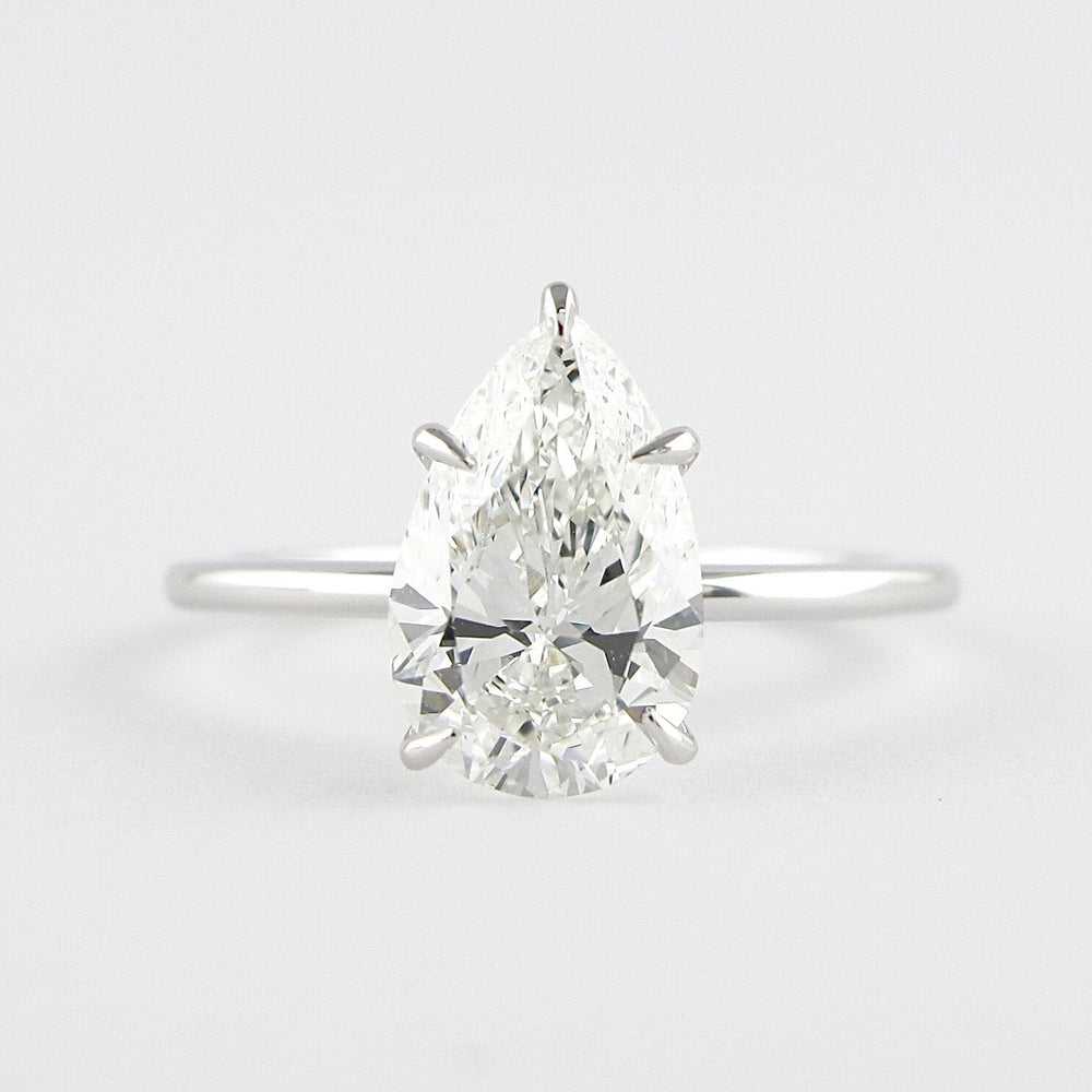 1.5 CT Pear Cut Solitaire Style Moissanite Engagement Ring 1