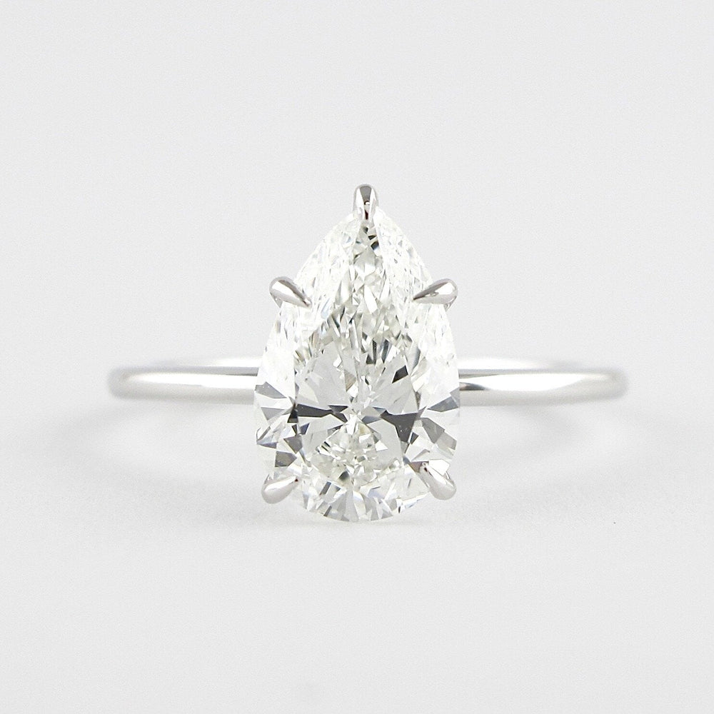 
                  
                    1.5 CT Pear Cut Solitaire Style Moissanite Engagement Ring 1
                  
                